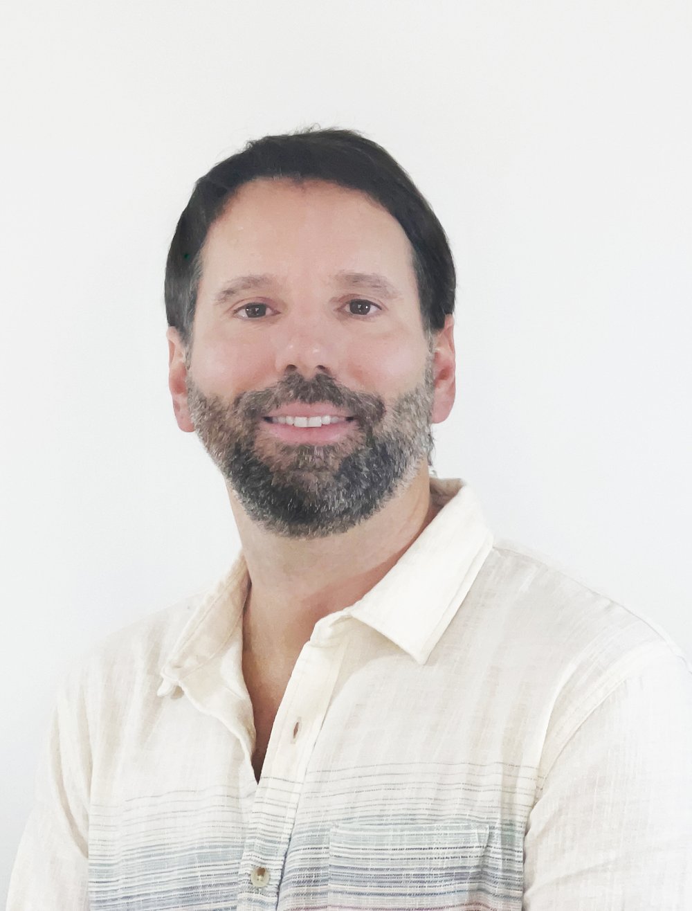 Headshot of Daniel Pinha wearing a white shirt